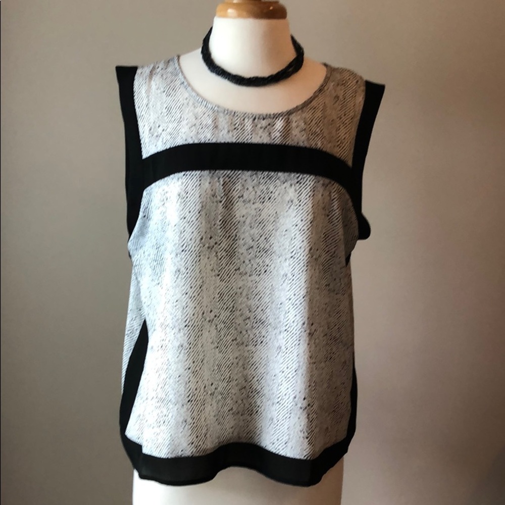 Black and white sleeveless blouse. Size L